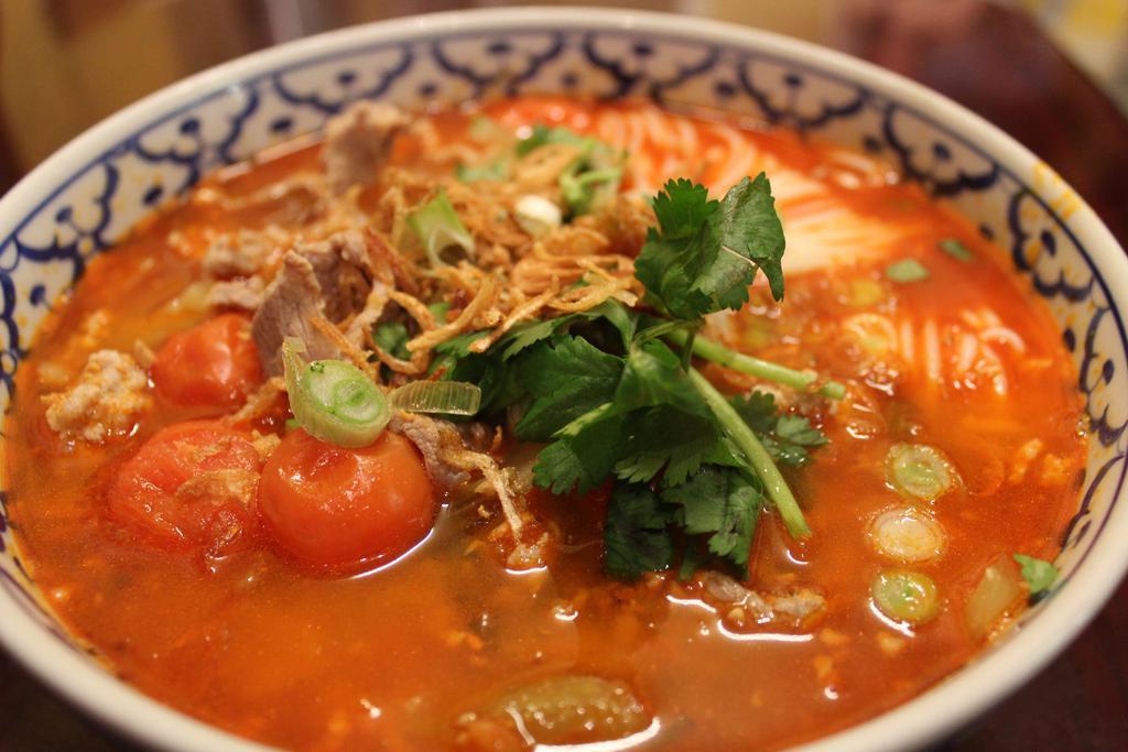 44. Khaknom Jin Nam Ngiao · Gluten-free. Choice of spice level. Special pork tomato broth soup served with round rice noodles, sliced pork, ground pork, diced tomatoes, and assorted vegetables.
