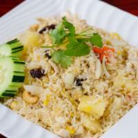 70. Pineapple Fried Rice · Fried rice with pineapple, eggs, raisin, cashew nuts, onions, and carrots.