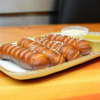 Pretzel Bread and Cheese · Pretzel sticks served with cheese fondue and dijonaisse sauce.