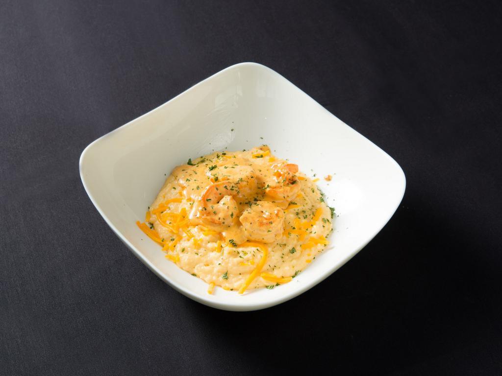 Shrimp and Grits · Creamy cheesy garlic grits served sauteed shrimp marinated in a beef roux.