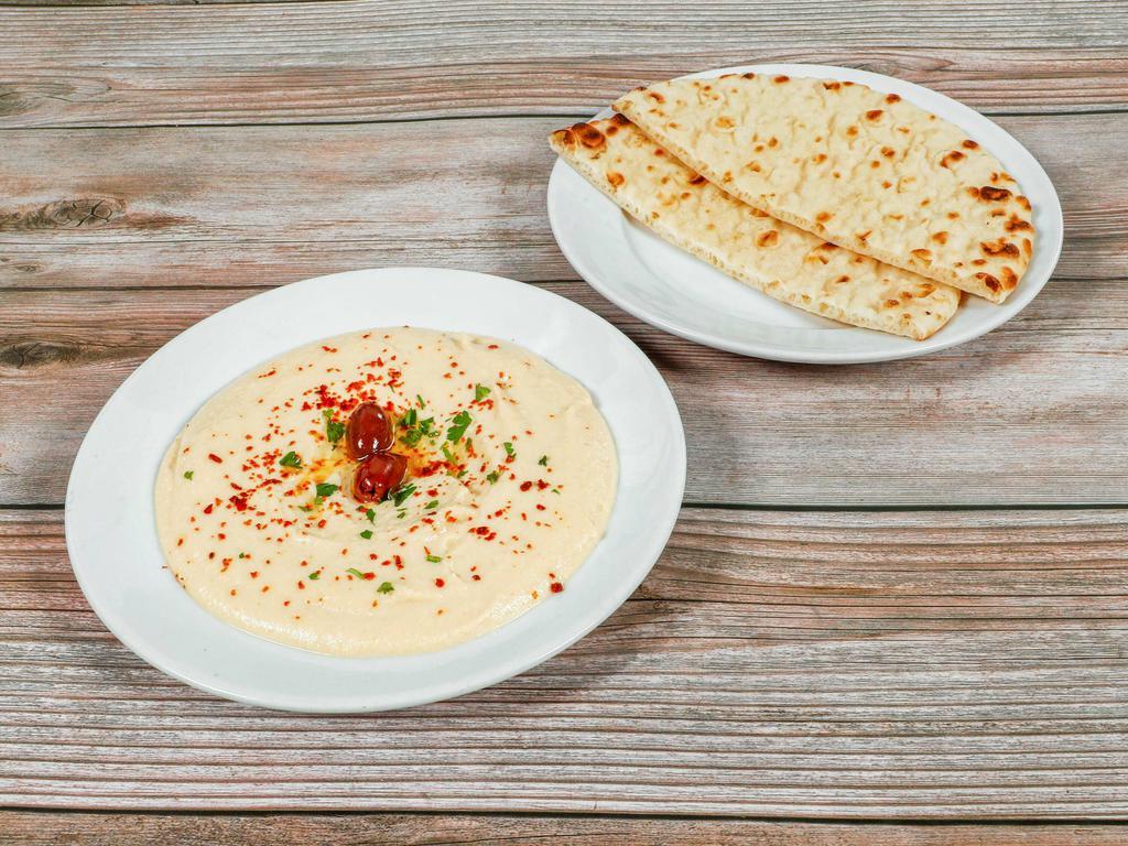 Hummus · A delightful dip of garbanzo beans with garlic, lemon juice, tahini, and olive oil.