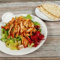 Chicken Gyro Salad · With fresh tomatoes, cucumber, lemon juice and olive oil dressing.  Served with pita bread.