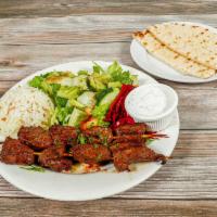 Beef Shish Kebab Plate · Seasoned and marinated beef cubes charcoal-grilled. Served with salad, rice, and pita bread.