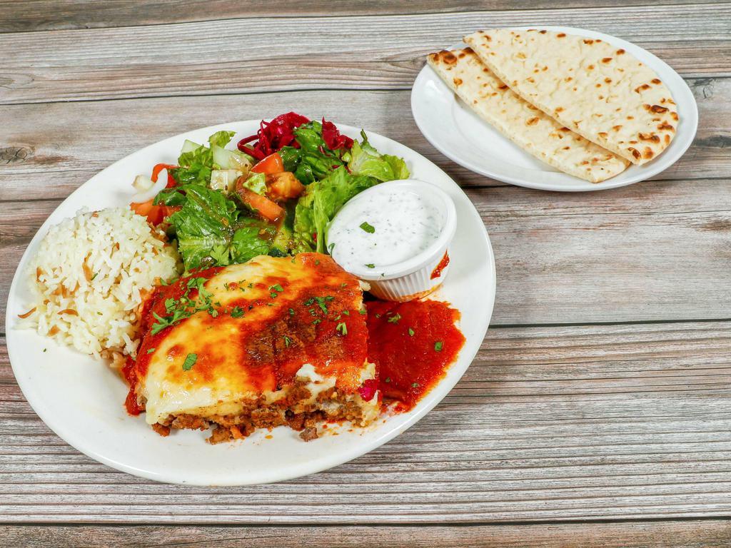Moussaka Plate · Layers of potato, ground meat, eggplant, Greek cheese, topped with bechamel sauce. Served with salad, rice, pita bread, and tzatziki sauce.