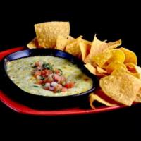 Azteca Queso Dip · Dip into a warm blend of selected cheeses, spinach and chiles, all baked together and served...