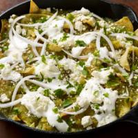 Chilaquiles · Comes with onion, sour cream and cheese.  Add two eggs or rice and beans for an additional c...