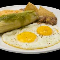 Breakfast Plate · 2 eggs, 1 tamale and rice and beans.