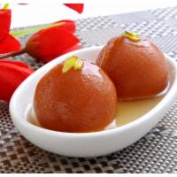 Gulab Jamun · Homemade cheese rounds and evaporated milk simmered in syrup flavored with rose water.
