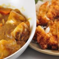 Japanese Chicken Curry Dinner · breaded fried chicken on a plate of white rice and served with Japanese curry