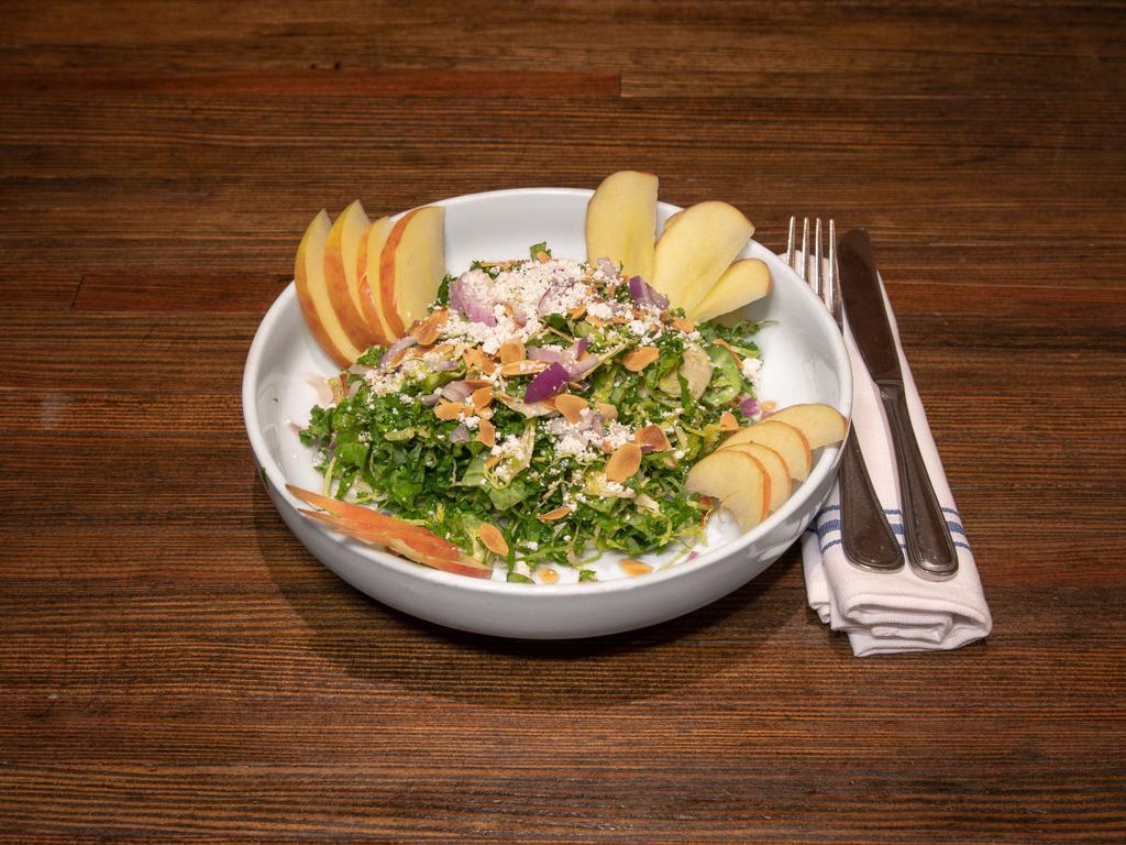Kale and Brussel Sprout Salad · Toasted almonds, ricotta salata, apple, red onion and apple cider vinaigrette.