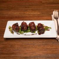 Dates · Blue cheese stuffed medjool dates, wrapped in bacon and balsamic pomegranate reduction.