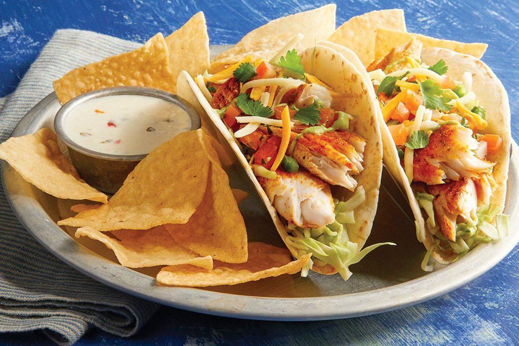 Blackened Mahi Mahi Tacos · With green cabbage, shredded cheese, cilantro, pico de gallo, avocado lime dressing, served with queso and tortilla chips.