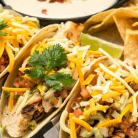 Blackened Chicken Tacos · With green cabbage, shredded cheese, cilantro, pico de gallo, avocado lime dressing, served ...