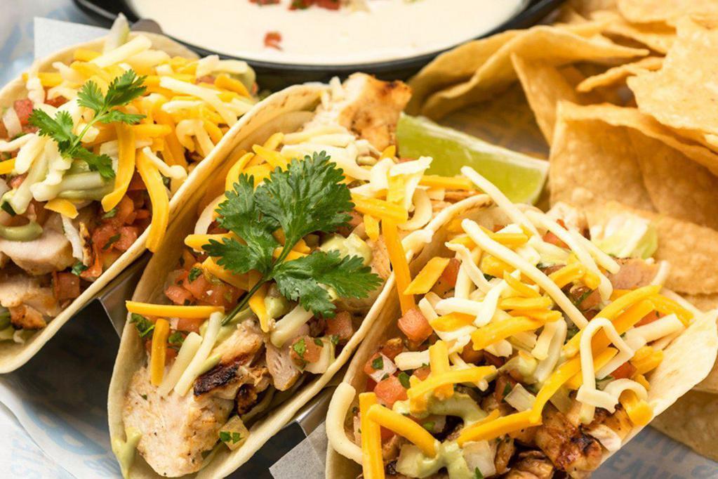 Blackened Chicken Tacos · With green cabbage, shredded cheese, cilantro, pico de gallo, avocado lime dressing, served with queso and tortilla chips.