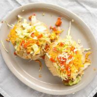 54. Puff Tacos · 2 puff flour tortillas filled wilh ground beef or shredded chicken sauteed and topped with s...