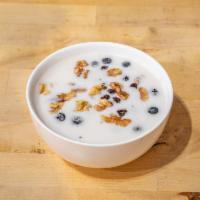 Overnight Oats · Blueberries, chia seeds, honey, and oats soaked overnight in almond milk.