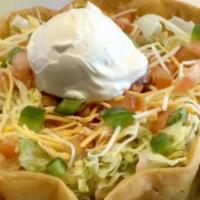 Taco Salad · Taco shell filled with beans, lettuce, cheese, pico de gallo, green peppers, and sour cream....
