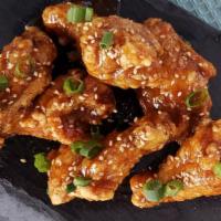 Soy Garlic Wings · Seasoned wings, soy garlic sauce, topped with green onions and sesame seeds
