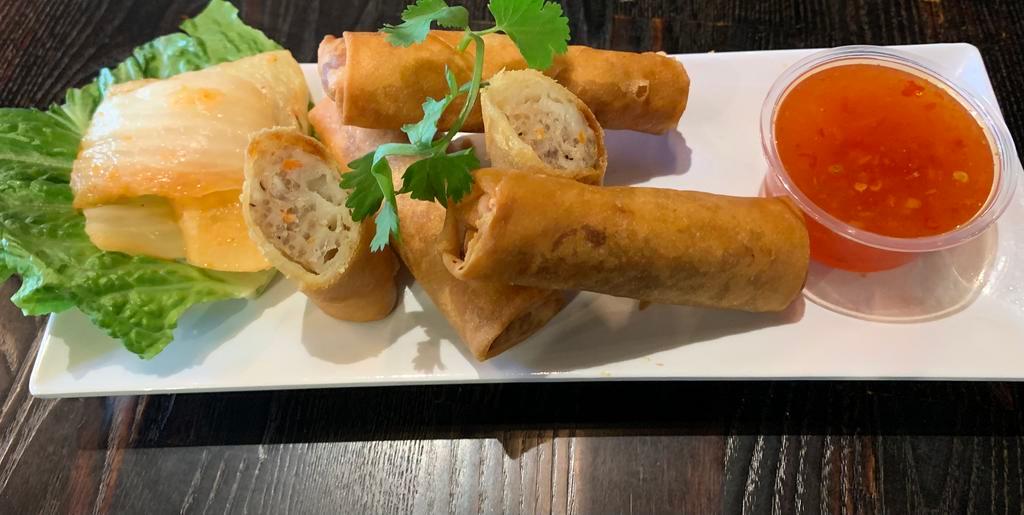 Fried Egg Rolls · Comes with 3 crispy fried egg rolls. A combination of pork and shrimp; served with kimchi and sweet and sour dipping sauce.