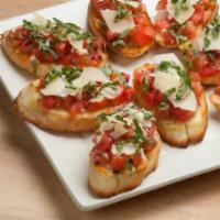Lou's Bruschetta · Roma tomatoes, fresh basil, olive oil and shaved Parmesan on garlic rounds.
