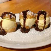 Bc Profiteroles Glacees · Vanilla ice cream profiteroles and chocolate sauce.