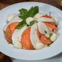 Caprese · Fresh mozzarella, tomato, basil and drizzled with olive oil.