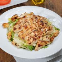 Chicken Caesar Salad · Marinated grilled chicken, romaine lettuce, croutons, shaved Parmesan and Caesar dressing.