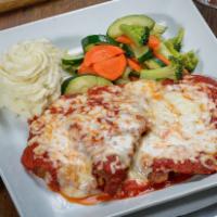 Veal Parmigiana · Fresh tomato sauce and smoothered with mozzarella cheese.
