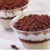 Tiramisu in a Glass · Sponge cake soaked in espresso, topped with mascarpone cream and dusted with cocoa powder