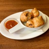 Mini Sausage Rolls · Our house made english banger meat wrapped in crispy puff pastry. served with curry ketchup. 