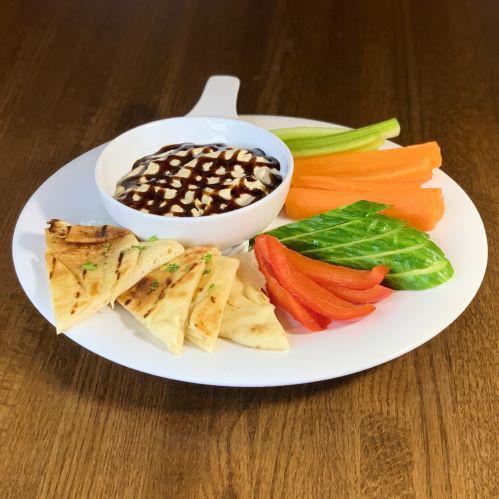 Hummus · creamy hummus drizzled with a balsamic reduction & served with grilled garlic naan bread & veggies.
