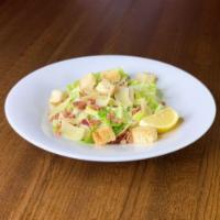 Caesar Salad · Crisp croutons, bacon bits and shaved Parmesan.