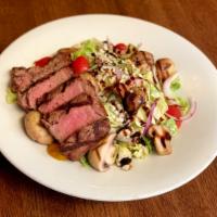 Steak Salad · 5oz striploin on a bed of romaine with grilled mushrooms, tomatoes, onions & bleu cheese cru...