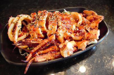 Grilled Whole Squid · Whole squid sliced and generously sauced.