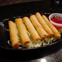 6 Piece Lumpia · Filipino style mini egg rolls filled with pork and veggies. Comes with a side of sweet and s...