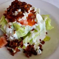 The Wedge Salad · Crisp iceberg lettuce, topped with creamy blue cheese dressing, blue cheese crumbles, diced ...
