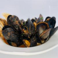 Mussels Buzzara · Tomato, garlic, herbs, bread crumbs, white wine.
