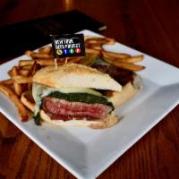 NYBP Famous Steak Sandwich · Tender, seasoned Sirloin steak topped with melted provolone cheese and sautéed spinach.  Ser...