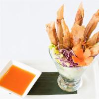 A4. Goong Graub · Crispy rolls stuffed with marinated shrimp. Served with homemade pineapple sauce.