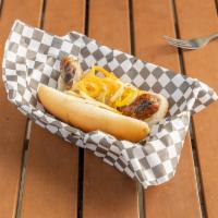 Montego Bay Jerk Chicken Sausage · Grilled chicken sausage seasoned with FiMi Kingston spices on a bun with sauteed onions, pep...
