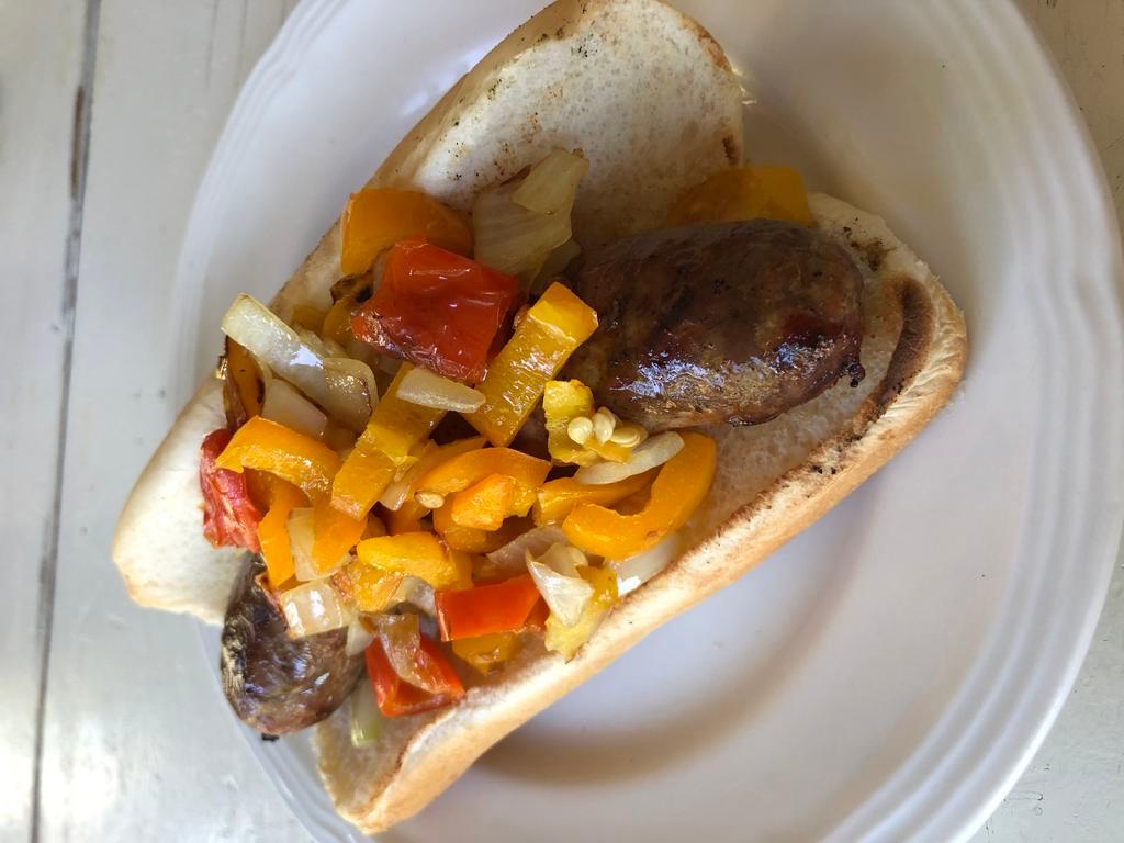 Boston Bay Jerk Pork Sausage · Grilled pork sausage seasoned with FiMi Kingston spices on a bun with sauteed onions, peppers.