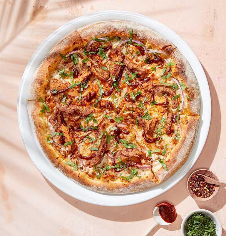 Plant-Based BBQ Chicken Pizza · Our iconic pizza, prepared with plant-based chicken. Vegetarian. 