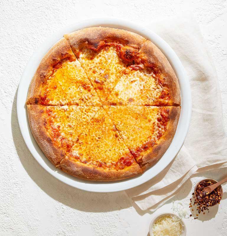 Traditional Cheese Pizza · Our tomato sauce with mozzarella and fresh mozzarella.
