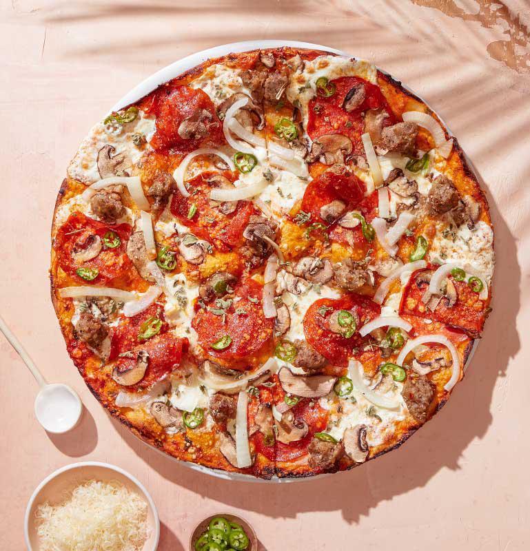 Spicy Milano Pizza  · Spicy marinara, serrano peppers, Italian sausage, spicy pepperoni, Cremini mushrooms, yellow onions, fresh Mozzarella & Romano and wild Greek oregano.