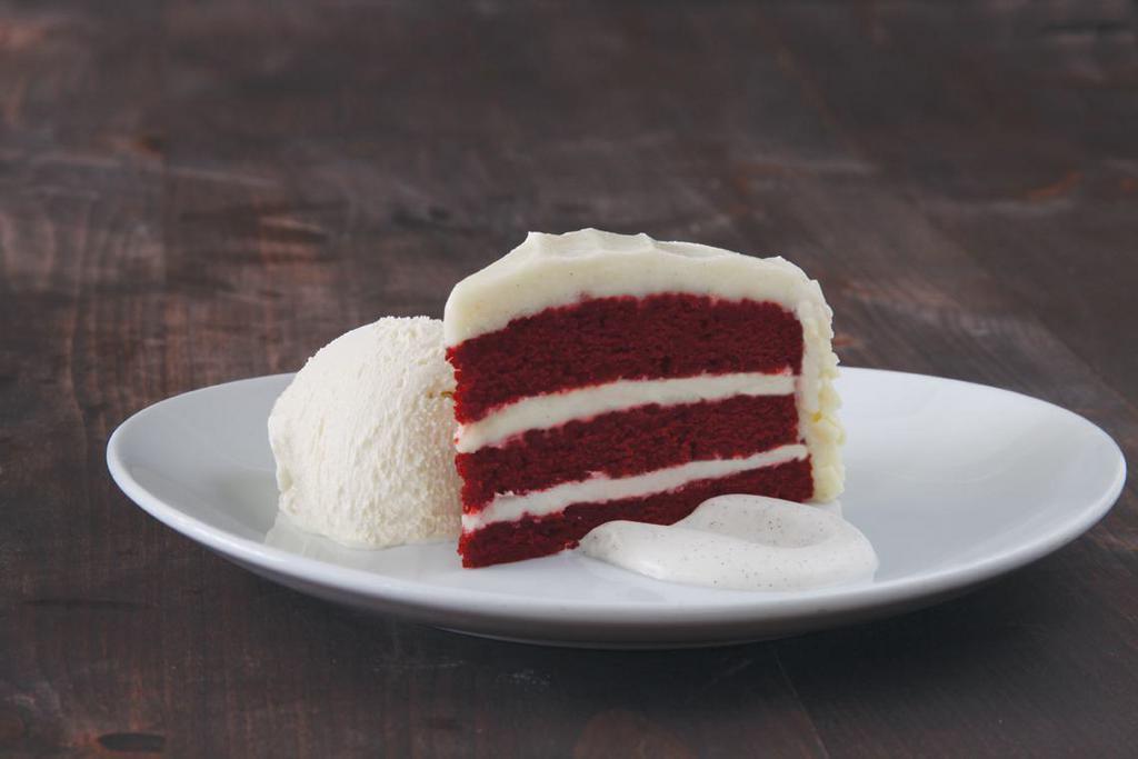 Red Velvet Cake · Frosted with hand-whipped vanilla bean cream cheese and white chocolate curls. Vegetarian.