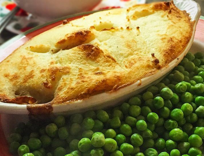 Cottage Pie · Minced beef, onion, and tomatoes topped with mashed potatoes and farmhouse cheddar cheese. Served with peas. Includes vegetables. 
