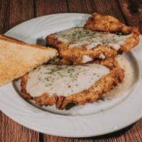 Country Fried Chicken Dinner  · Two country fried chicken breasts served over mashed potatoes with white gravy.