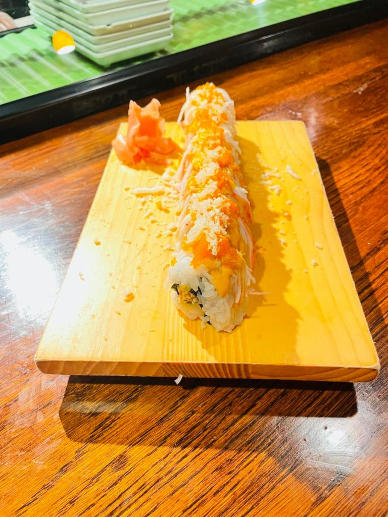 Texan Roll · Spicy crabmeat, avocado inside, topped with crab stick, tempura crumbles, spicy mayo, and masago. Spicy.
