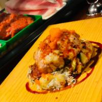 Jumbo Volcano Roll · Baked crabmeat, avocado, spicy tuna, masago and sprinkle eel sauce. Spicy.