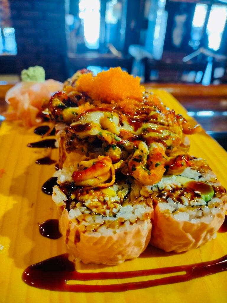 Snow Cone Roll · Avocado, crab stick, cream cheese inside, wrapped in soy paper, topped with baked crawfish, eel sauce, and masago.